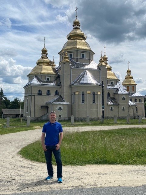 Adam Shephard stands in front of a Ukrainian church. Shephard, whose parents live in Katy, leads an organization that helps Ukrainian refugees.